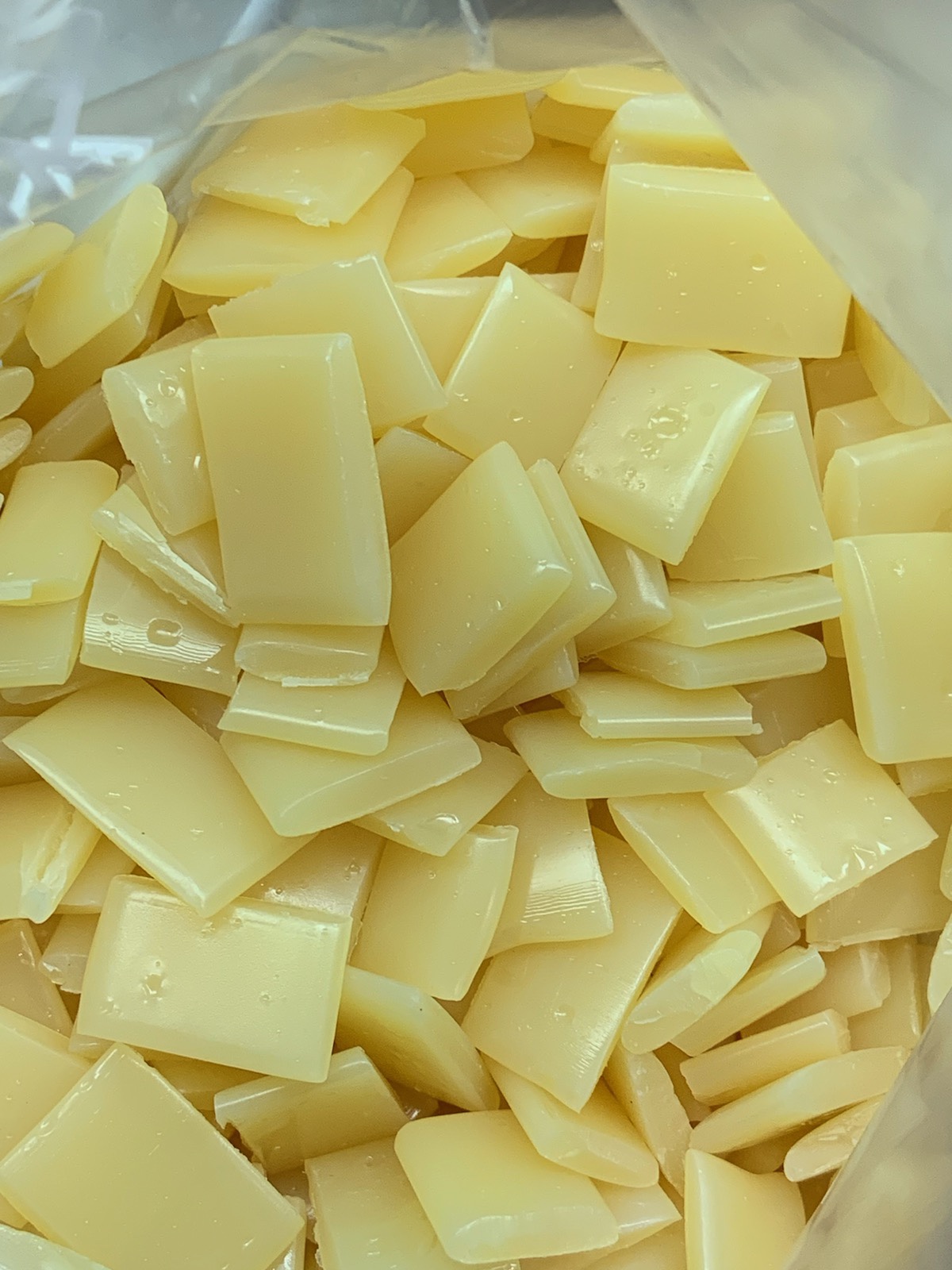 Cream hot-melt adhesive chips in a bag